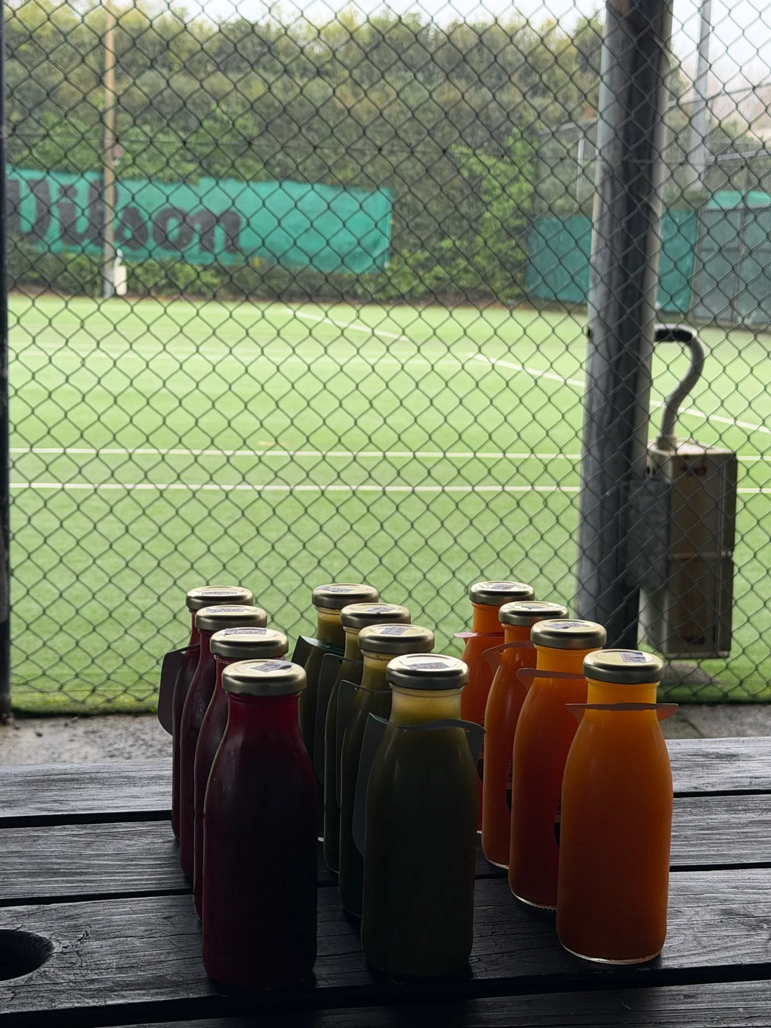 Cold-pressed juices lined up courtside at O-Social