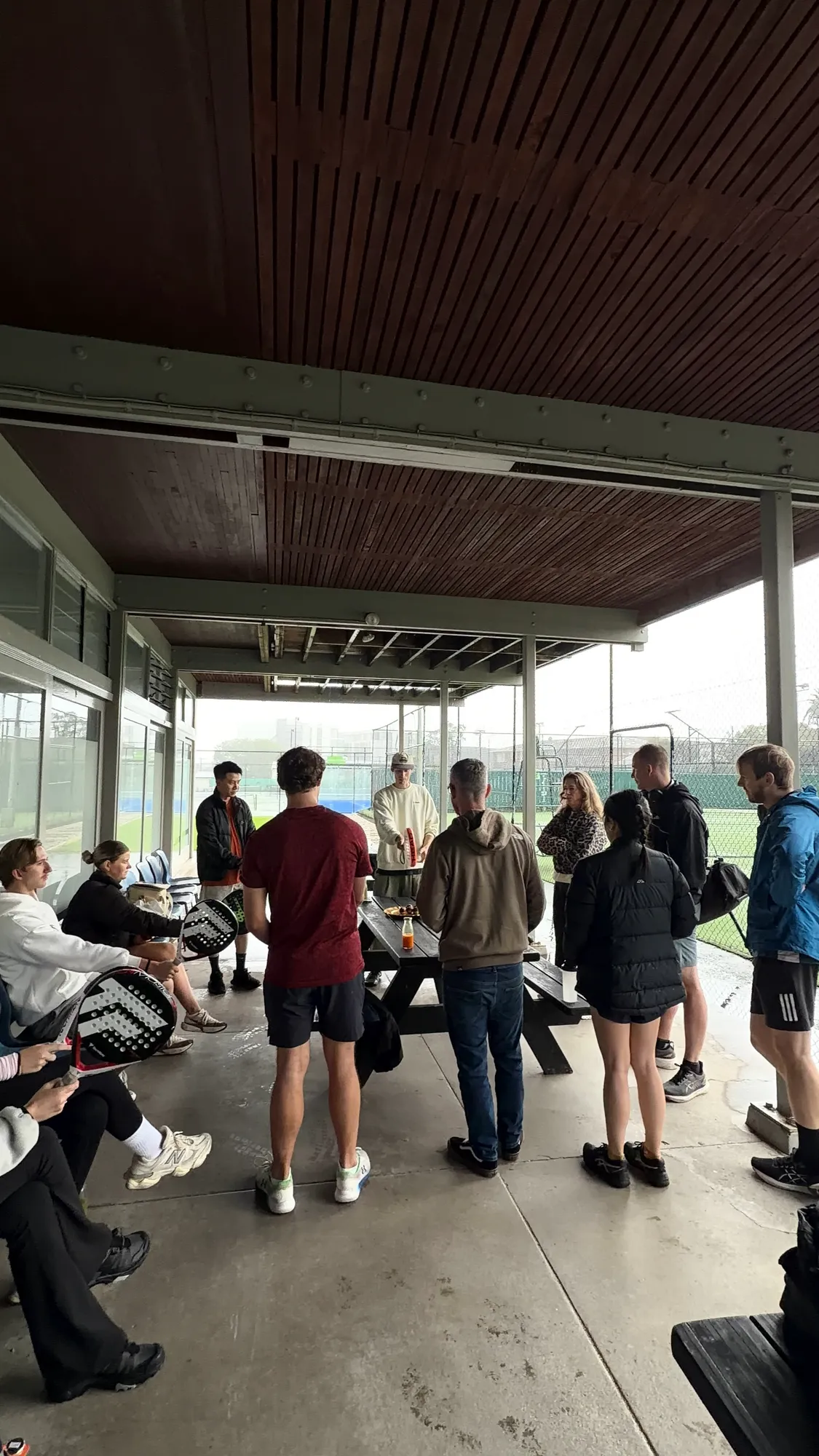 Guests gathered at the clubhouse with rackets at the start of O-Social